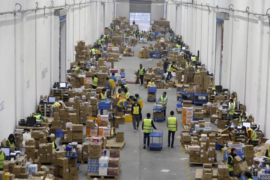 Warehouse workers sorting and consolidating packages in China logistics center