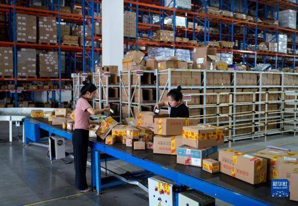A typical scene inside a Freight2Me China consolidation warehouse. Staff prepare multiple incoming small parcels on a conveyor for inspection and repacking into standard international master cartons, a key step in the 8-step China parcel consolidation workflow for multiple suppliers