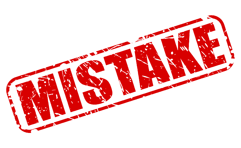 A distressed red rubber stamp reading "MISTAKE" placed diagonally on a white background.